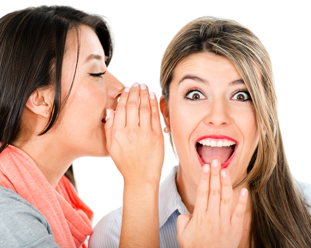 two women sharing a secret